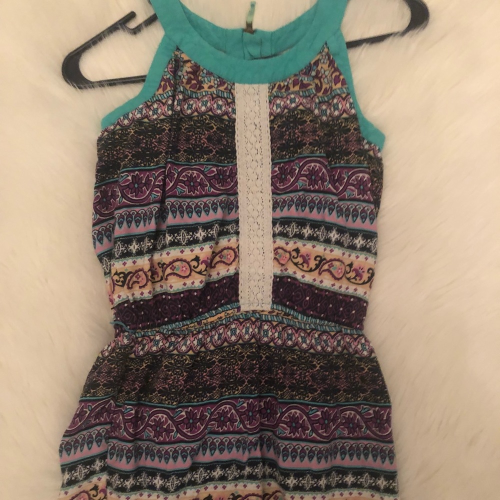 A patterned romper with a sip up back.